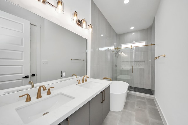 full bath featuring a freestanding tub, a sink, a shower stall, and double vanity