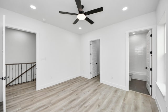 unfurnished bedroom with baseboards, ensuite bath, light wood-style flooring, and recessed lighting