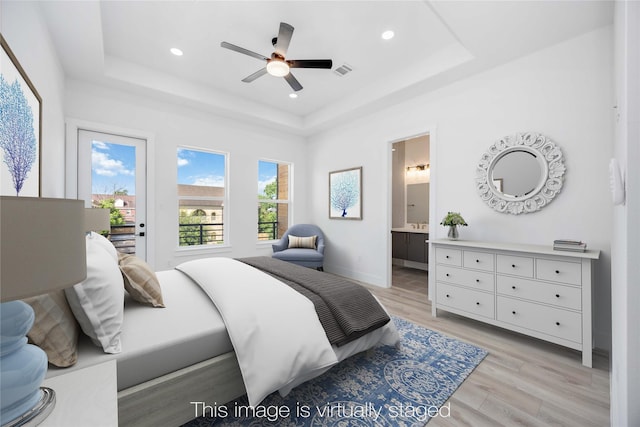 bedroom with light wood-style flooring, recessed lighting, visible vents, access to outside, and a raised ceiling