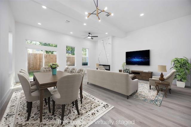 dining space featuring a chandelier, beam ceiling, light wood-style flooring, and recessed lighting