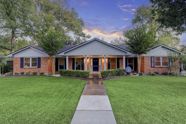 view of front of property featuring a lawn and covered porch