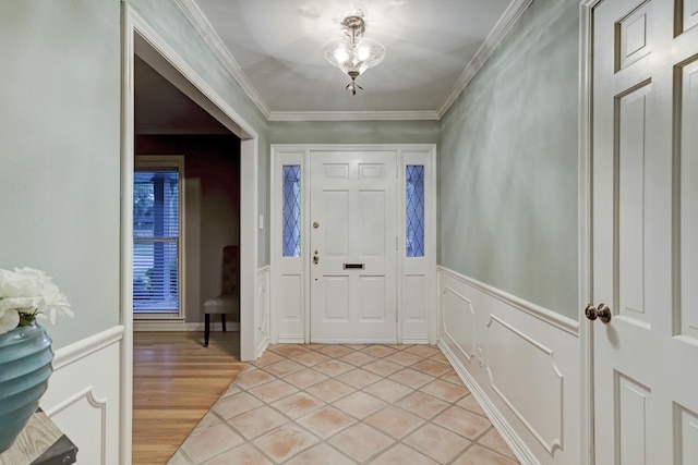 tiled foyer entrance with crown molding