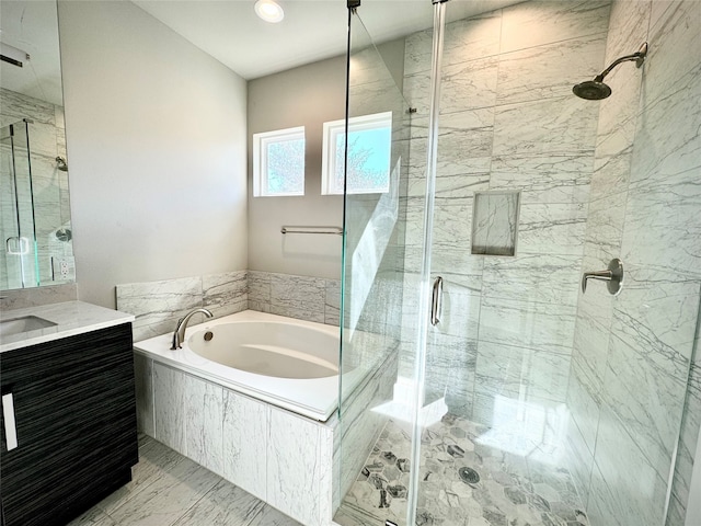 bathroom with vanity and independent shower and bath