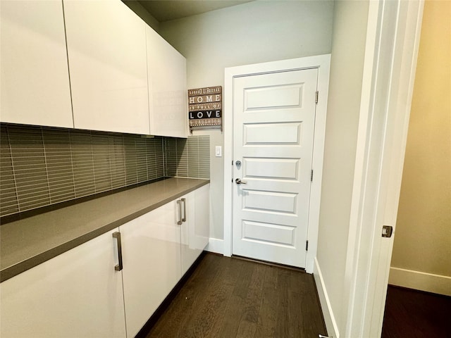 laundry room with dark wood-type flooring