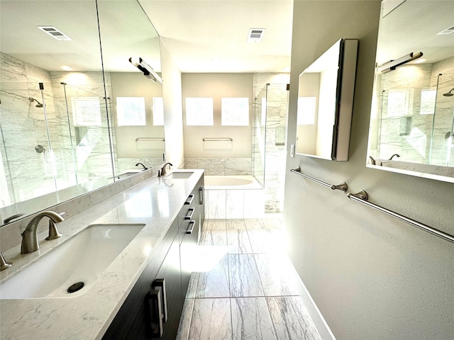 bathroom featuring vanity and shower with separate bathtub