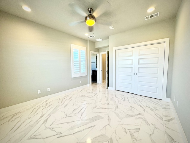 unfurnished bedroom featuring ceiling fan and a closet