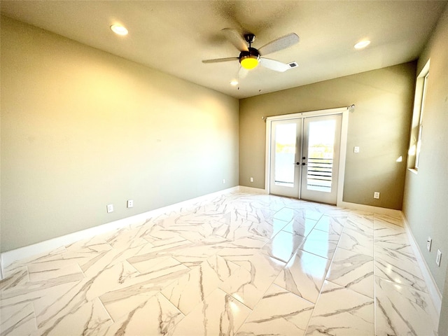 spare room with ceiling fan and french doors