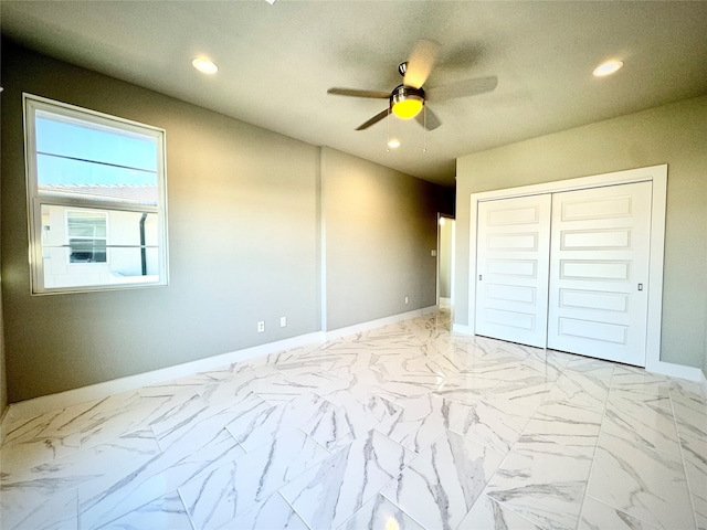 unfurnished bedroom featuring ceiling fan and a closet