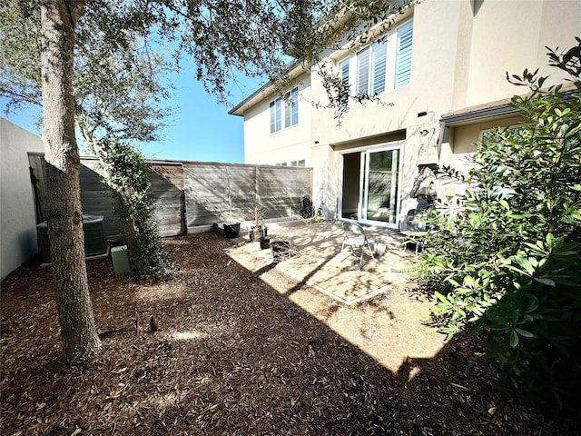 view of yard featuring cooling unit and a patio