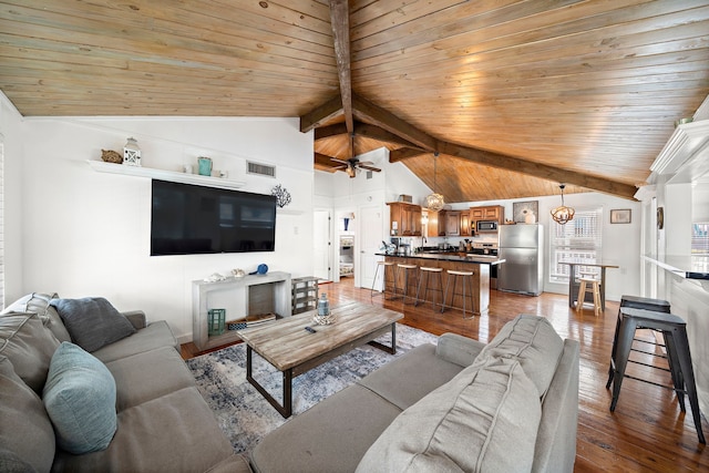 living room featuring ceiling fan, vaulted ceiling with beams, wooden ceiling, and light wood-type flooring