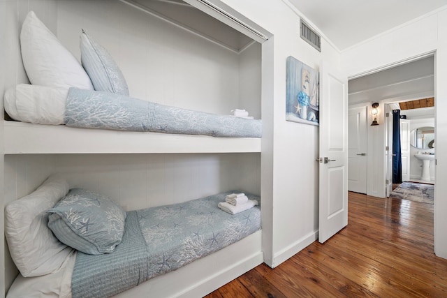 bedroom featuring ornamental molding and dark hardwood / wood-style floors