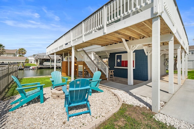 view of patio with a deck with water view