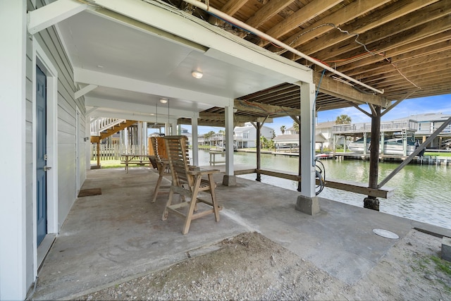 view of patio featuring a water view and a dock