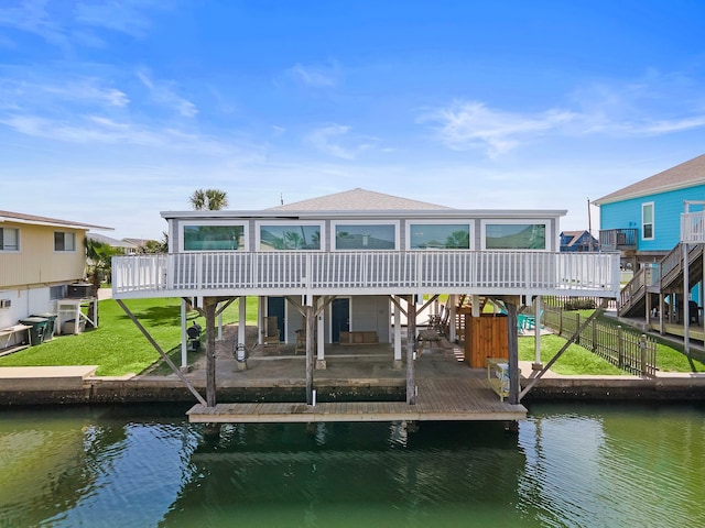 view of dock with a deck with water view and a patio area