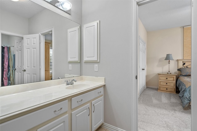 bathroom featuring vanity and baseboards