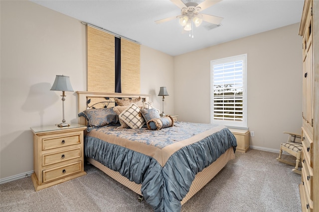 carpeted bedroom featuring a ceiling fan, visible vents, and baseboards