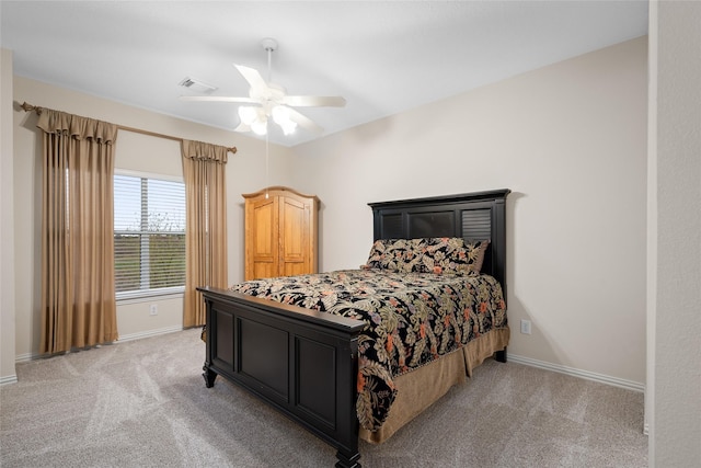 bedroom with a ceiling fan, light colored carpet, visible vents, and baseboards