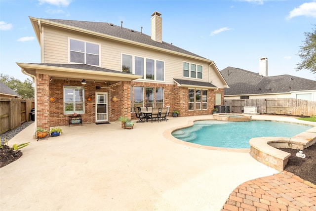 back of property featuring a patio, brick siding, and a fenced backyard