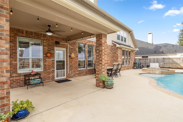 view of patio / terrace with a pool with connected hot tub, a fenced backyard, a ceiling fan, and central air condition unit