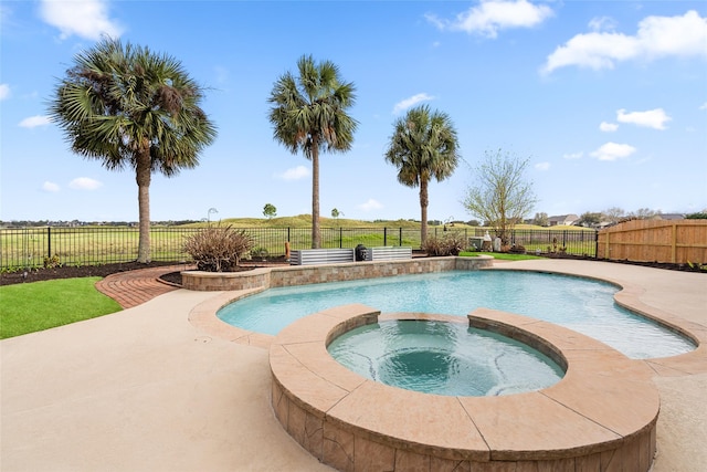 view of pool with a patio area, a fenced backyard, and a pool with connected hot tub