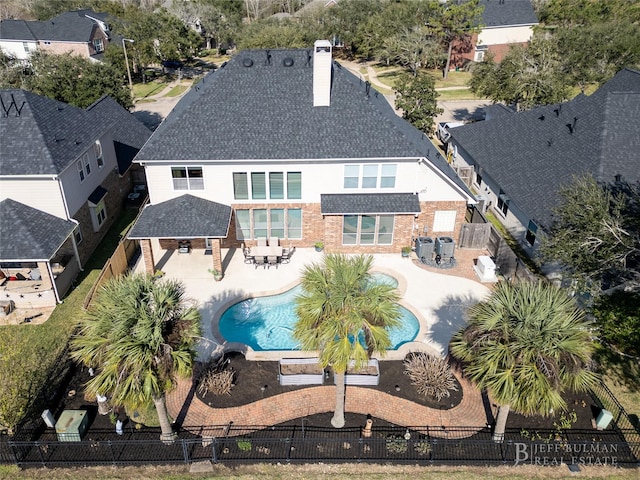 rear view of property with a fenced backyard, a fenced in pool, and a patio