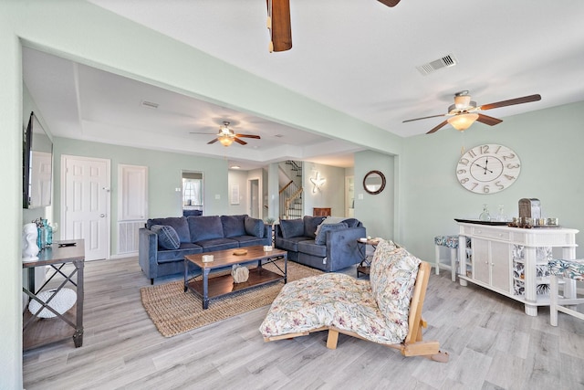 3418 Miramar Dr, Shoreacres, TX 77571 - living room featuring ceiling fan, a tray ceiling, and light hardwood / wood-style floors