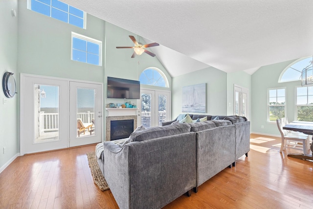 3418 Miramar Dr, Shoreacres, TX 77571 - living room with ceiling fan, high vaulted ceiling, light hardwood / wood-style floors, and a textured ceiling