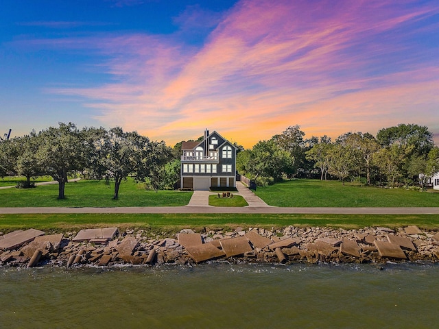 3418 Miramar Dr, Shoreacres, TX 77571 - back house at dusk with a yard