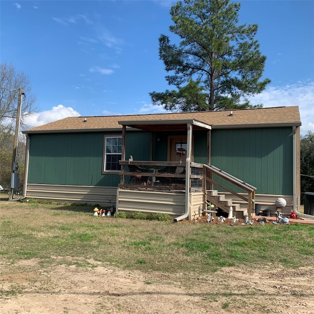 rear view of property featuring a yard