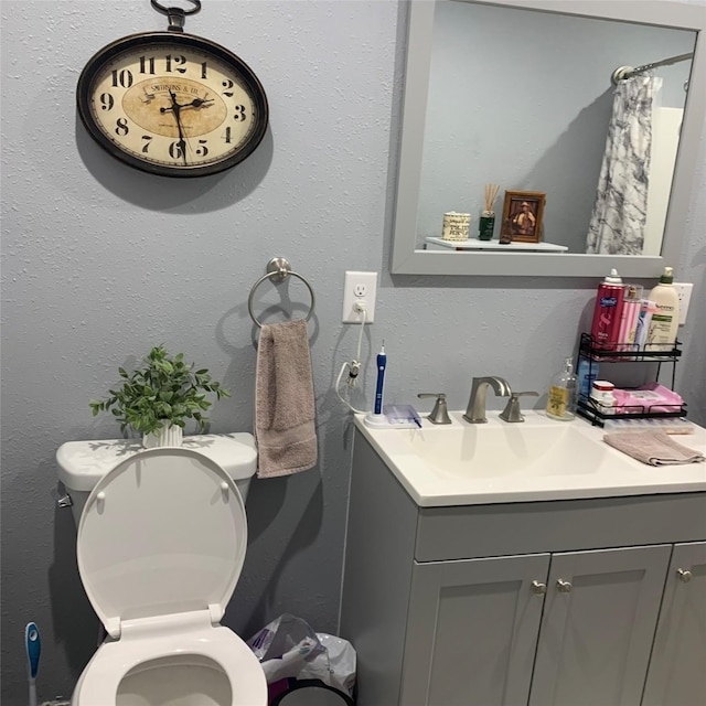 bathroom featuring vanity and toilet