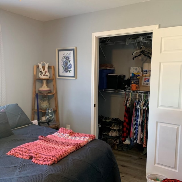 bedroom featuring wood-type flooring and a closet