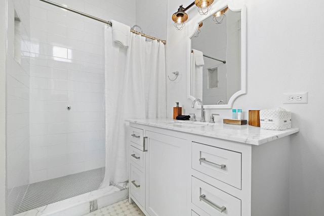 bathroom with walk in shower and vanity