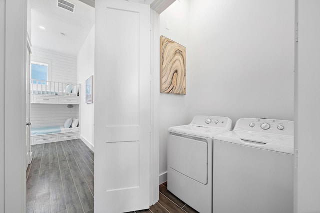 laundry area featuring dark hardwood / wood-style floors and washing machine and clothes dryer