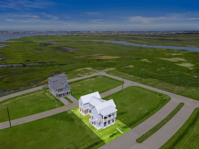 birds eye view of property featuring a water view and a rural view