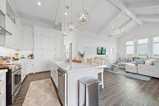 kitchen with hanging light fixtures, an island with sink, appliances with stainless steel finishes, and sink