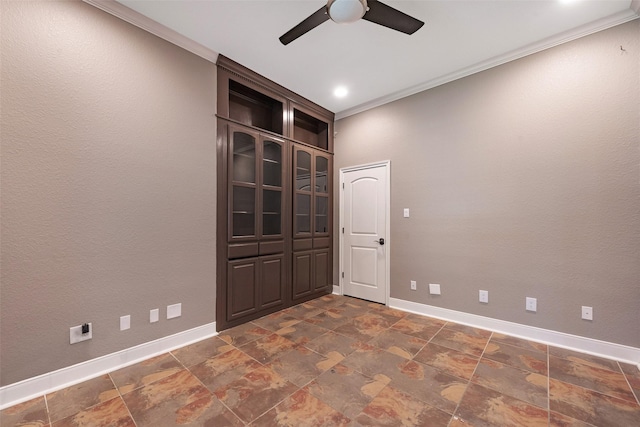 spare room with crown molding and ceiling fan