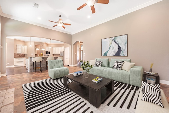 living room featuring crown molding and ceiling fan