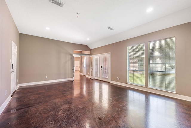 spare room featuring lofted ceiling