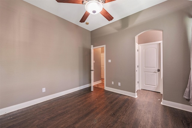 unfurnished bedroom featuring ceiling fan and dark hardwood / wood-style flooring