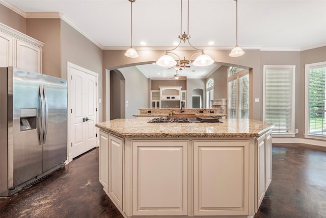 kitchen with hanging light fixtures, a kitchen island, and appliances with stainless steel finishes