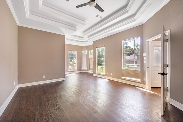 spare room featuring dark hardwood / wood-style floors, ceiling fan, a tray ceiling, and crown molding