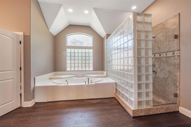 bathroom featuring hardwood / wood-style flooring, vaulted ceiling, and separate shower and tub