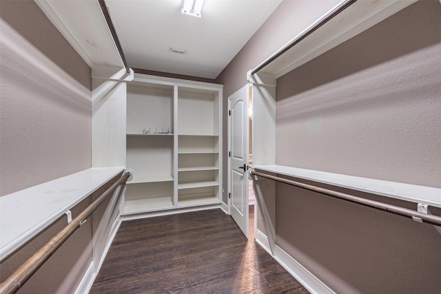 spacious closet with dark hardwood / wood-style floors