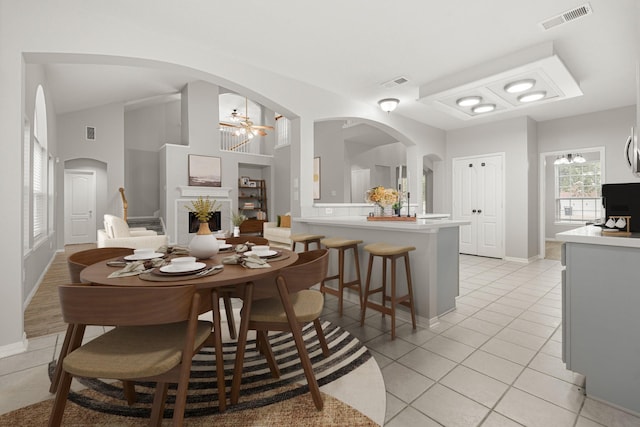 tiled dining room with high vaulted ceiling