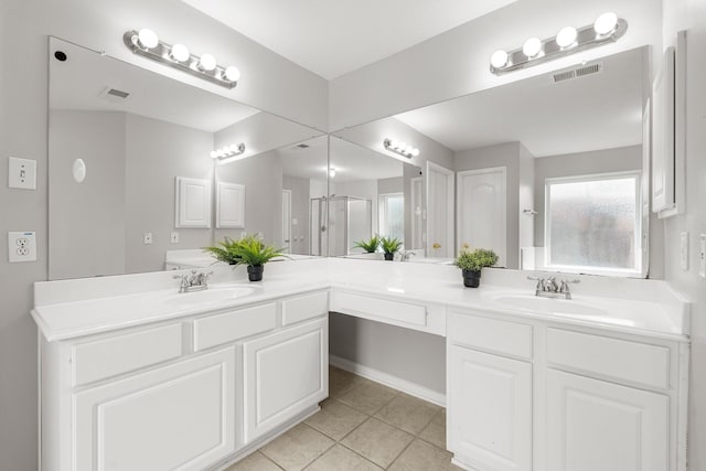 bathroom with vanity, tile patterned floors, and walk in shower