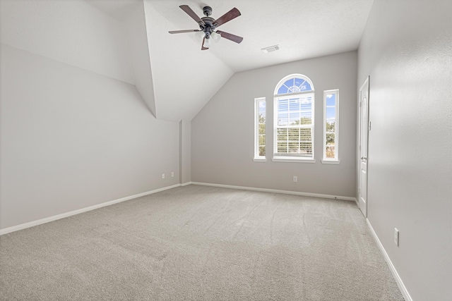 additional living space featuring ceiling fan, lofted ceiling, and light carpet