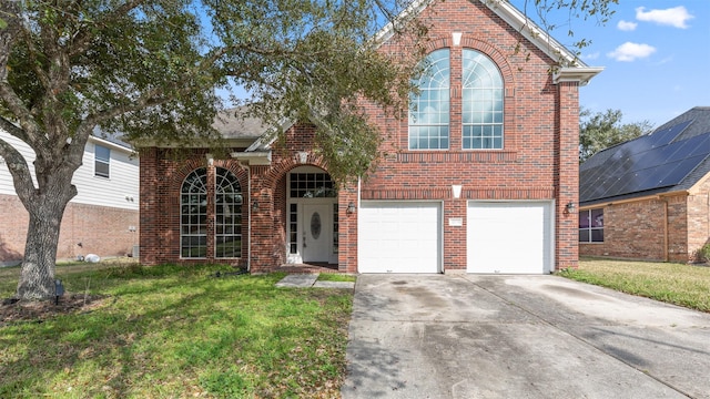 view of property with a garage and a front yard