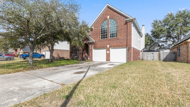 view of property featuring a garage and a front lawn