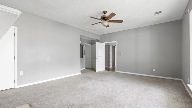 unfurnished bedroom featuring ceiling fan, carpet floors, and a textured ceiling