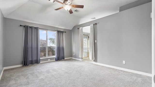 carpeted spare room with ceiling fan and lofted ceiling